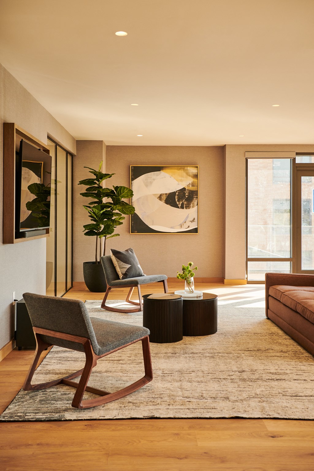 a living room with a couch and chairs and a rug