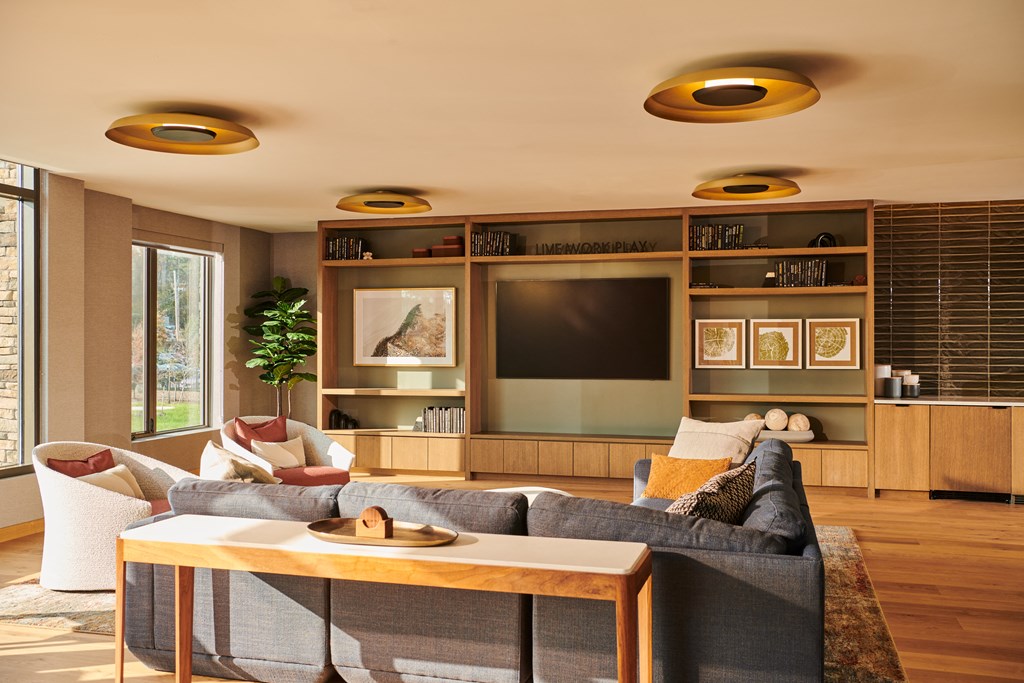 a living room with a couch and a coffee table and a television
