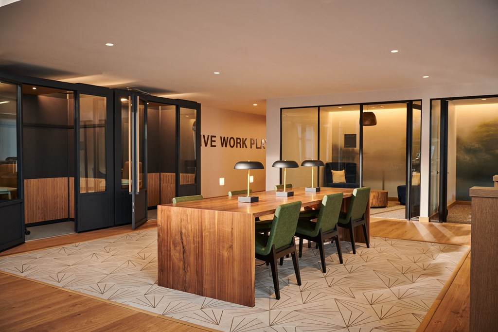 a large conference room with a wooden table and chairs