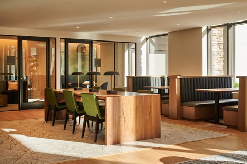a dining room with a wooden table and chairs