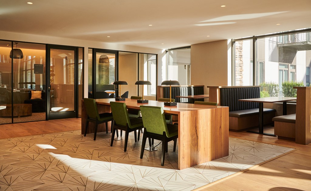 a restaurant with a wooden table and chairs in a lobby