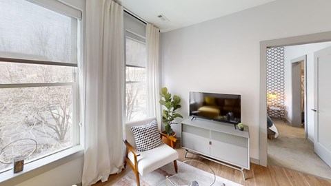A living room with a television and a chair.