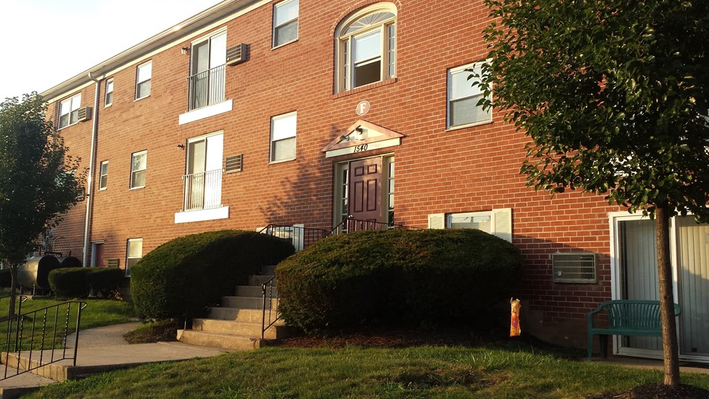 a brick apartment building with stairs in front of it