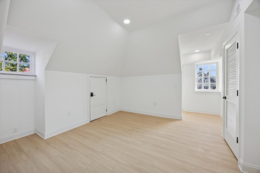 A room with white walls and wooden flooring.