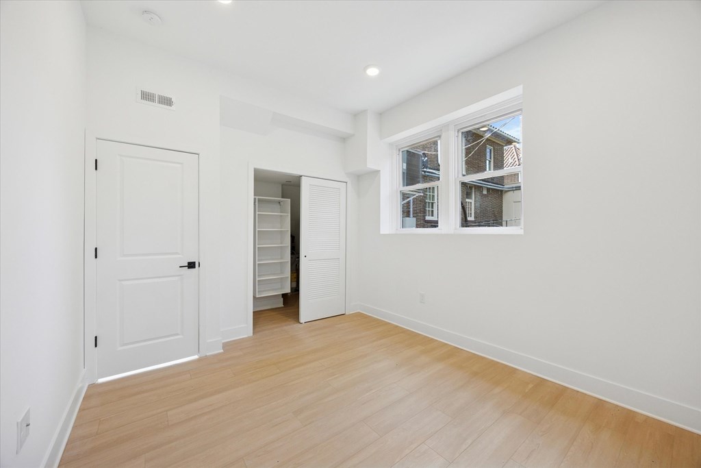 A white room with a door and a window.
