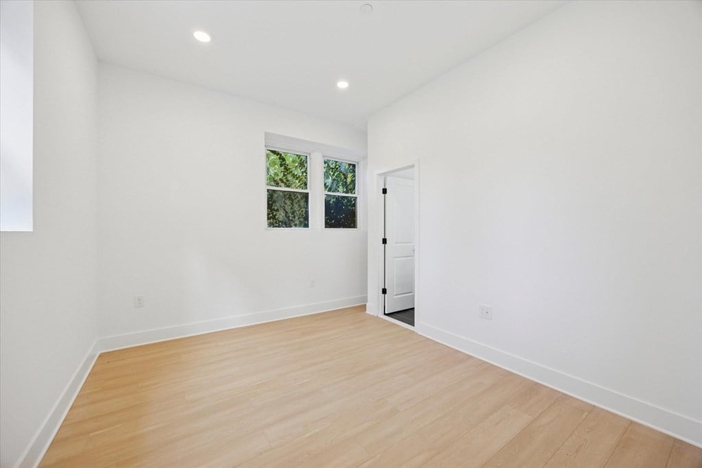 A room with a wooden floor and a door.