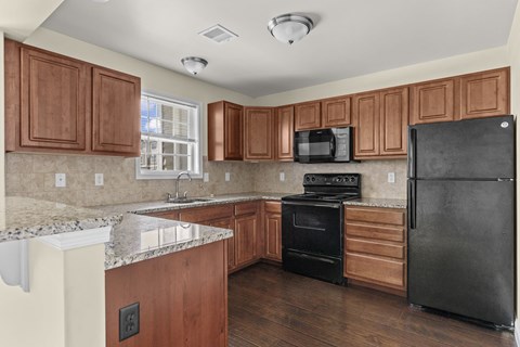 Kitchen with backsplash and granite Countertops at The Reserve at Manada Hill