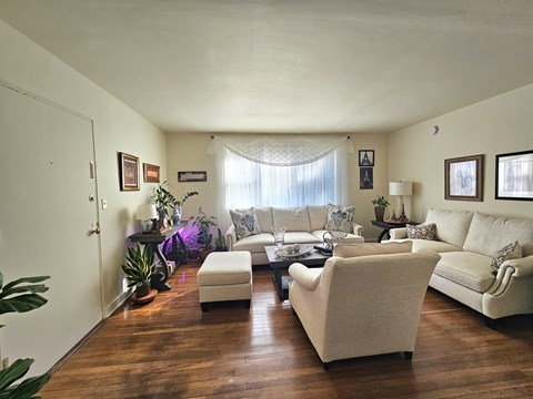 A living room with a white couch and a white chair.
