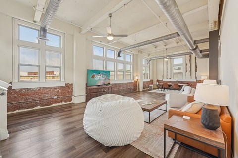 A living room with a white chair and a brown table.
