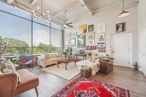 A living room with a large rug and a sofa.