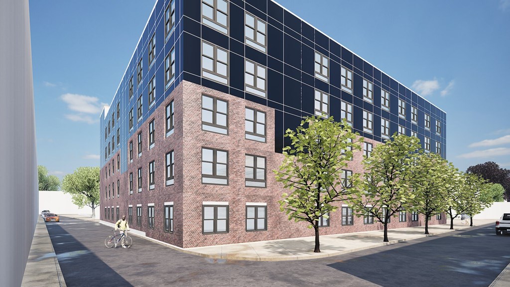A large red brick building with a blue sky in the background.