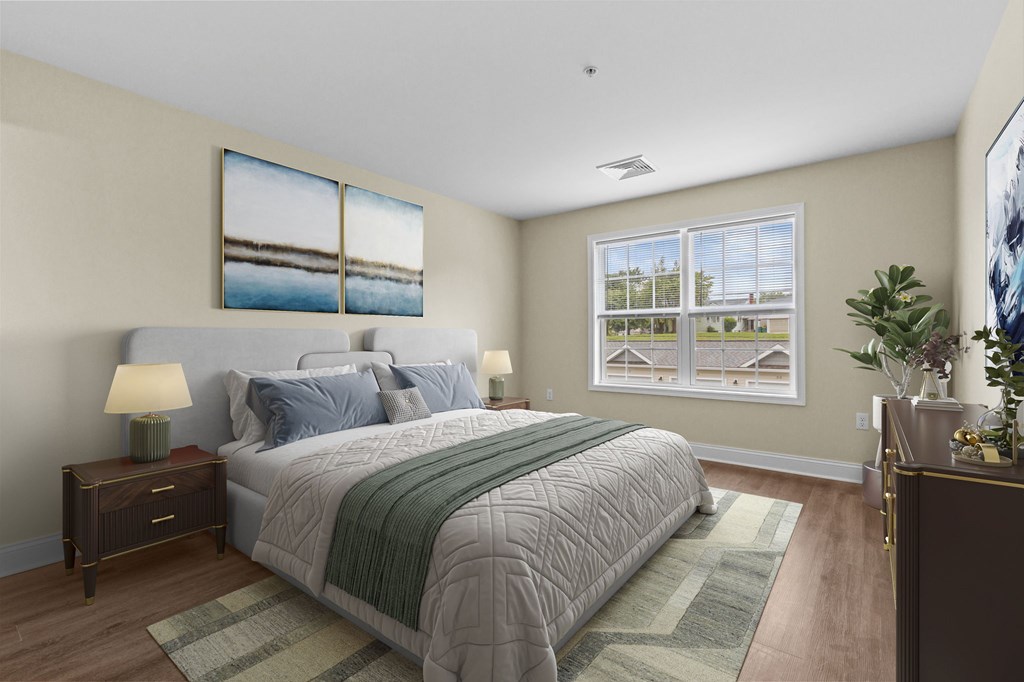 A bedroom with a large bed and a painting on the wall.