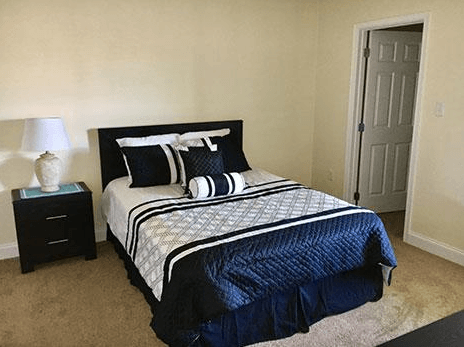 a bedroom with a bed and a white door