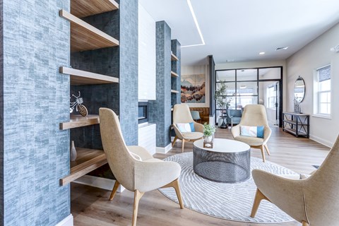 A modern living room with a grey textured wall and a wooden shelf.
