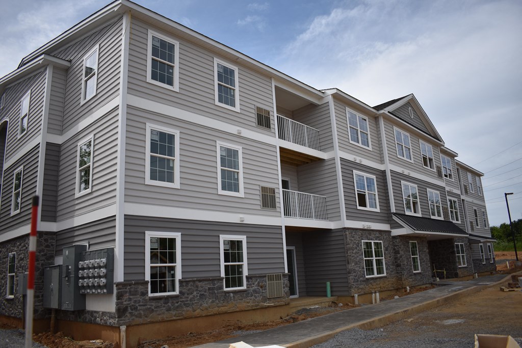 a new apartment building being constructed on the corner of a street