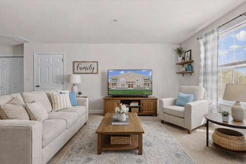 A living room with a couch, chair, and coffee table.