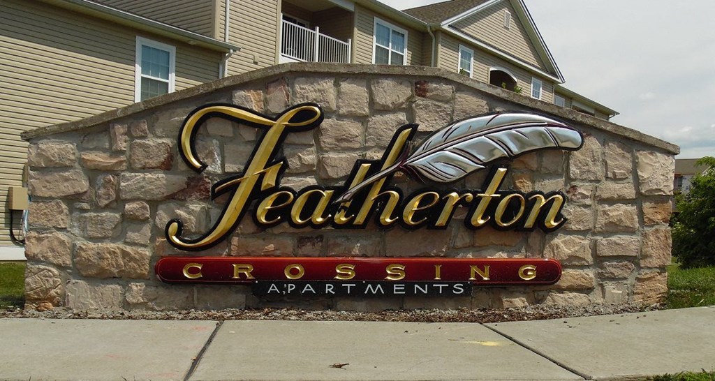 a sign on the side of a stone building