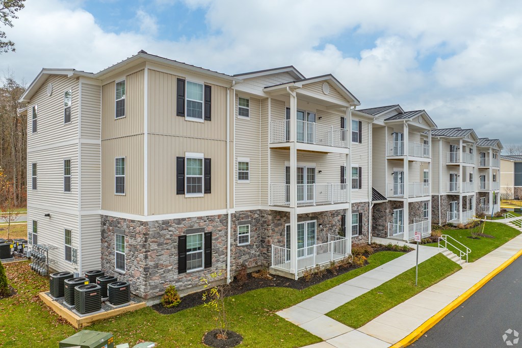 Apartment building with a mix of stone and siding exteriors.