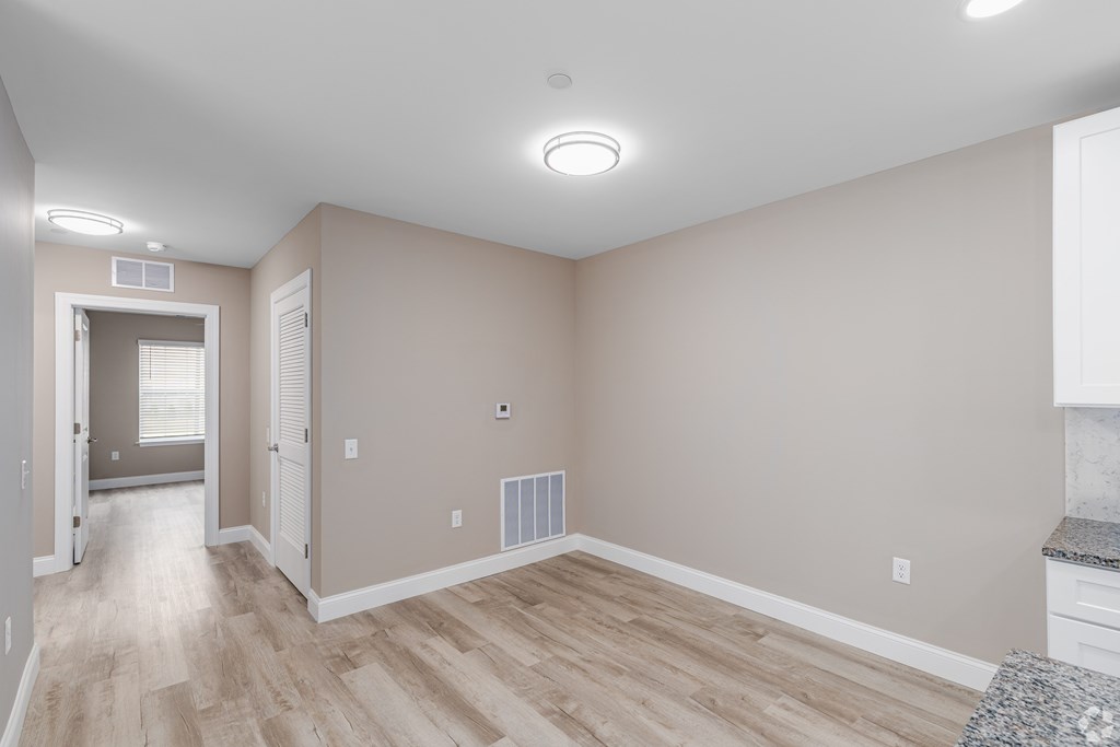 A room with a wooden floor and white walls.