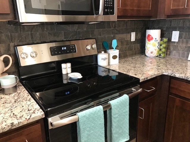 a kitchen with a stove and a microwave