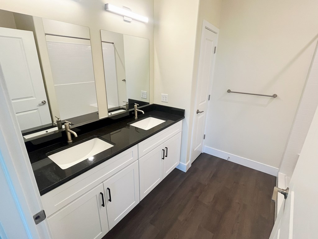 Double Sink Vanity with  stunning black granite countertops at Ponds at Village Greens