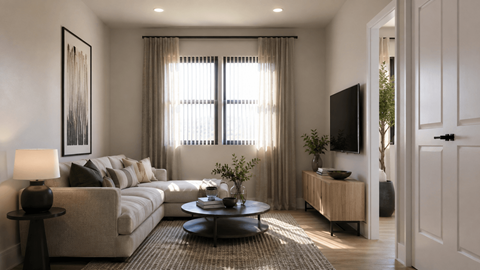 A modern living room with a large window and a flat screen TV.