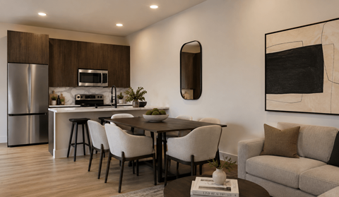 A modern kitchen with a dining table and chairs.