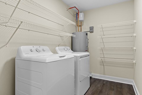 A small laundry room with a washer and dryer.