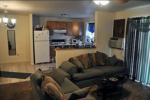 a living room with a couch and a kitchen