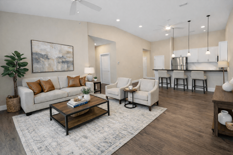 A living room with a white couch, a coffee table, and a painting on the wall.