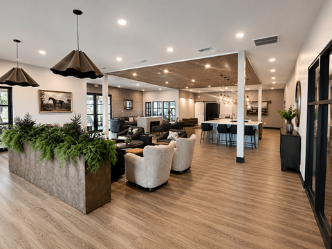 A modern living room with a large planter in the center.