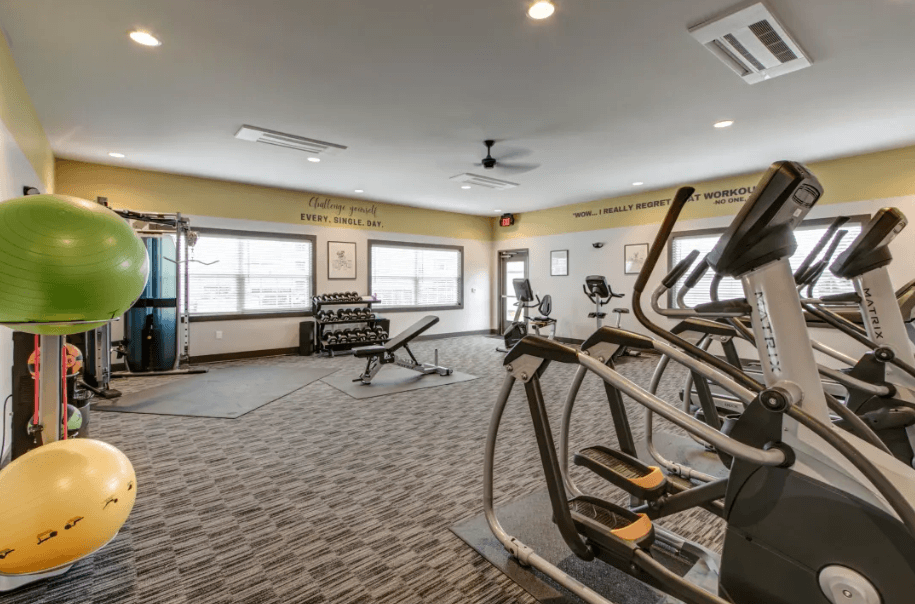 On Site Fitness Center. Showing Treadmills, Yoga Ball with Lifting Equipment in back.