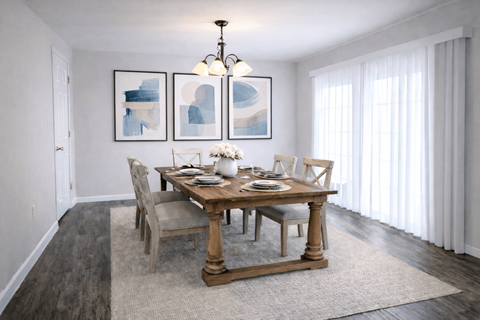A dining room with a wooden table and chairs.