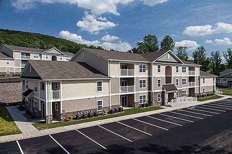 a large apartment building with a parking lot