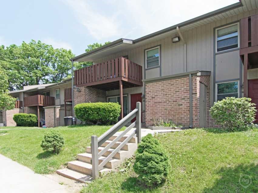 the front of an apartment building with stairs