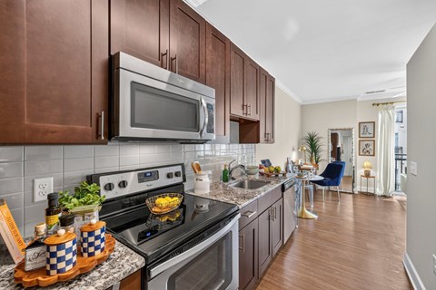 A modern kitchen with a stove top oven and microwave.
