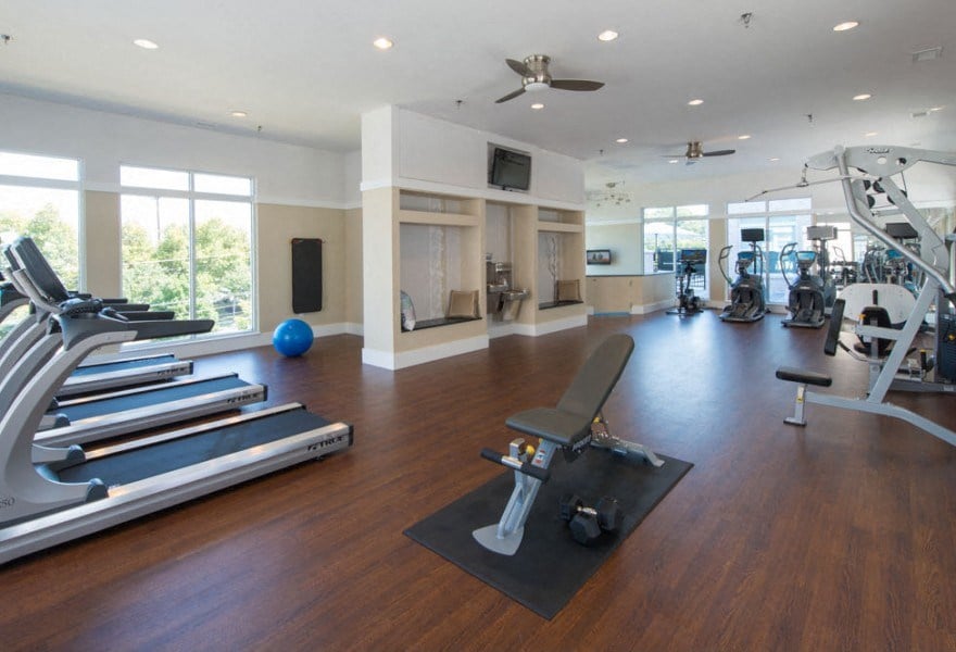 A spacious gym with a variety of equipment including treadmills, weights, and exercise machines.