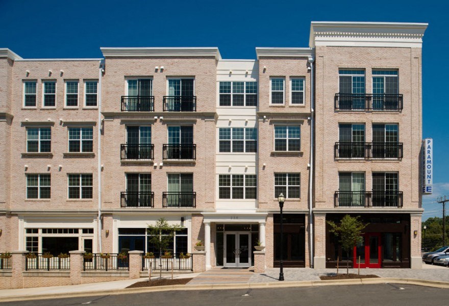 A large building with a red door in front.