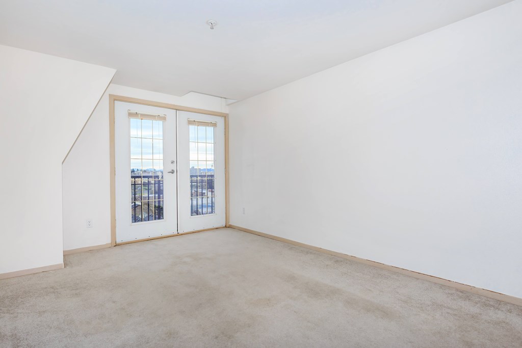 Empty room with a window and a door.