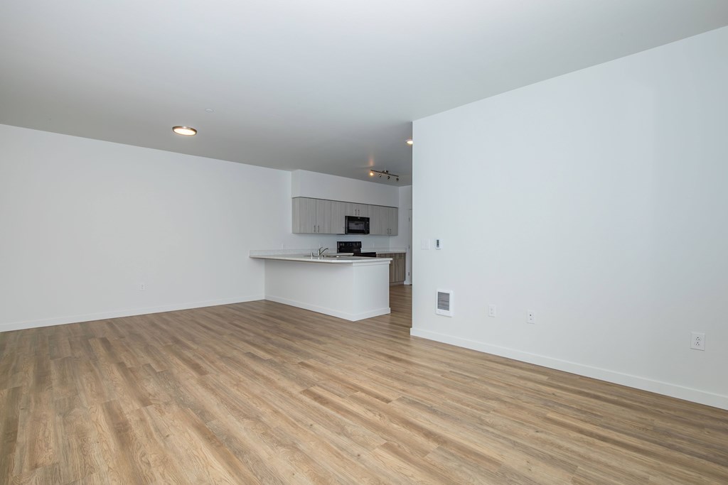 A room with wooden floors and white walls.