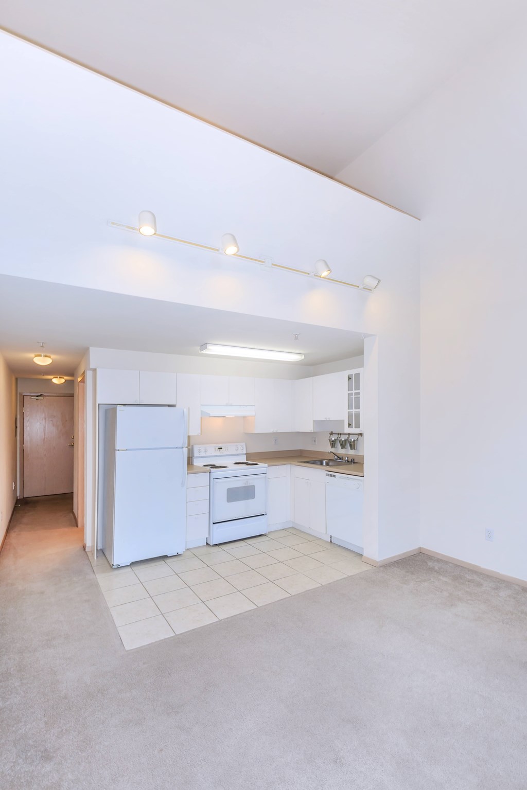 A kitchen with white appliances and a white refrigerator.