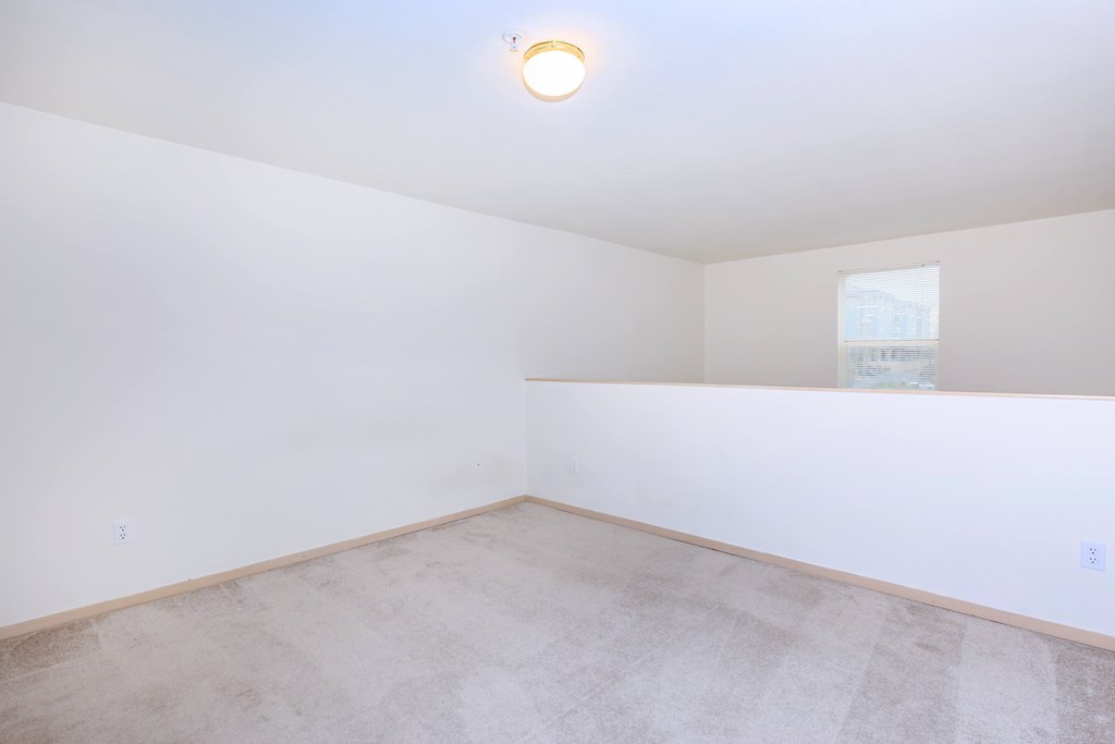 A room with a light on the ceiling and a window on the wall.