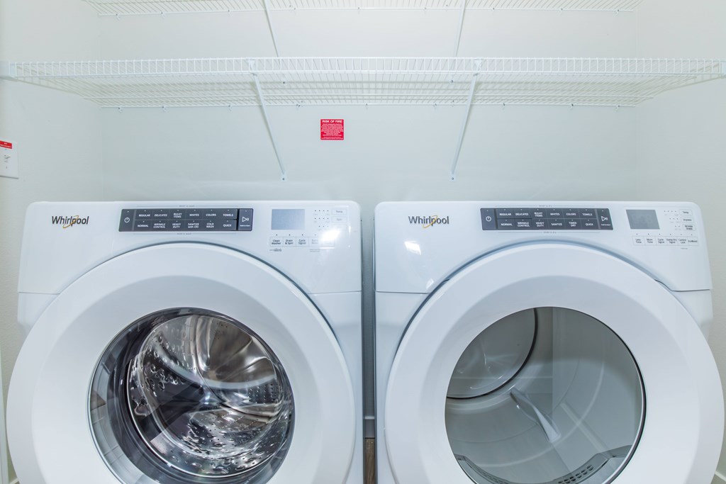 Two Whirlpool washing machines are side by side.
