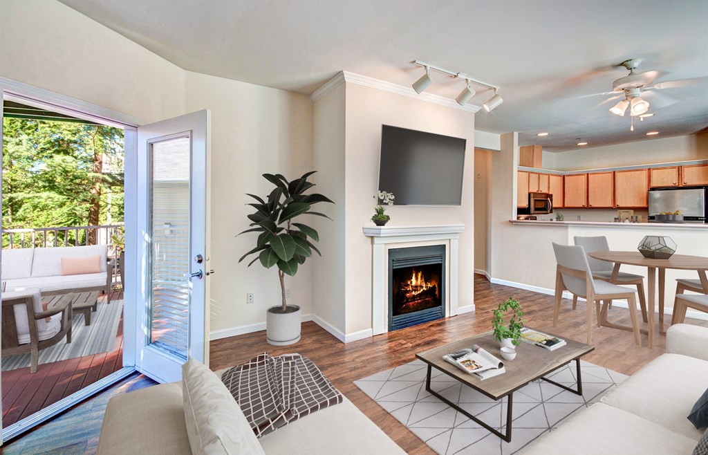 living space with outdoor access A living room with a fireplace and a television.