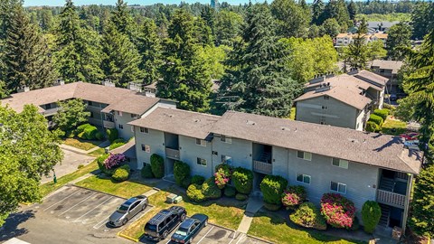 A large white building with a parking lot in front of it.
