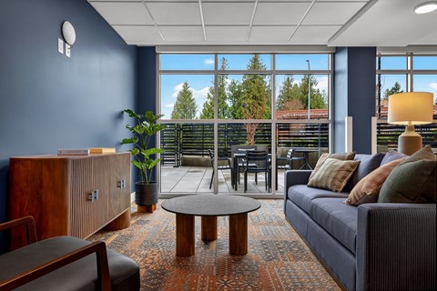 A living room with a blue couch and a wooden coffee table.