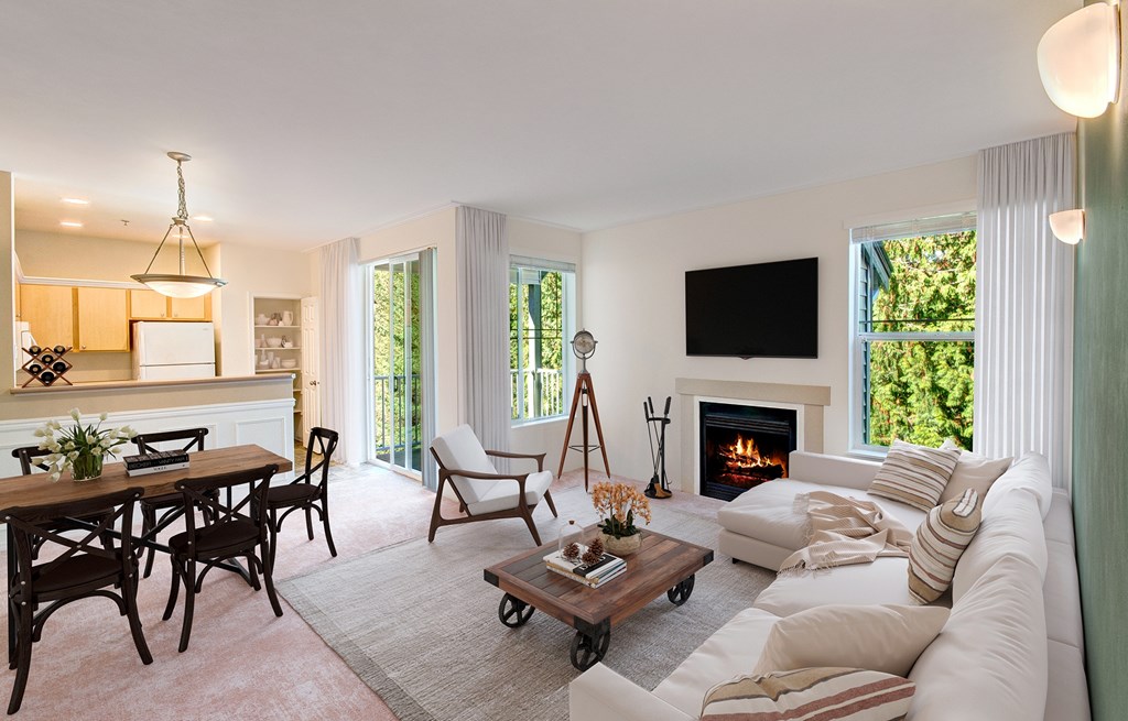 A living room with a fireplace and a flat screen TV mounted on the wall.