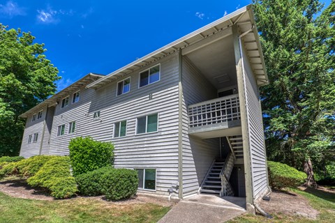 A two-story residential building with a balcony on the second floor.