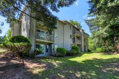 A building with a green lawn in front of it.