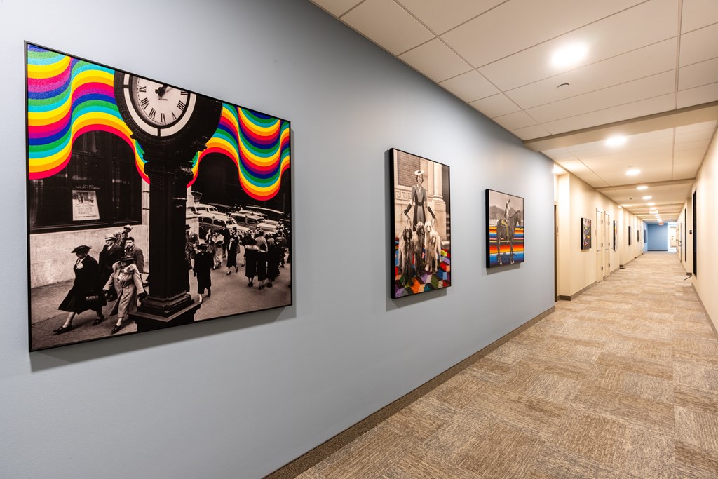 A hallway with a series of pictures on the wall.